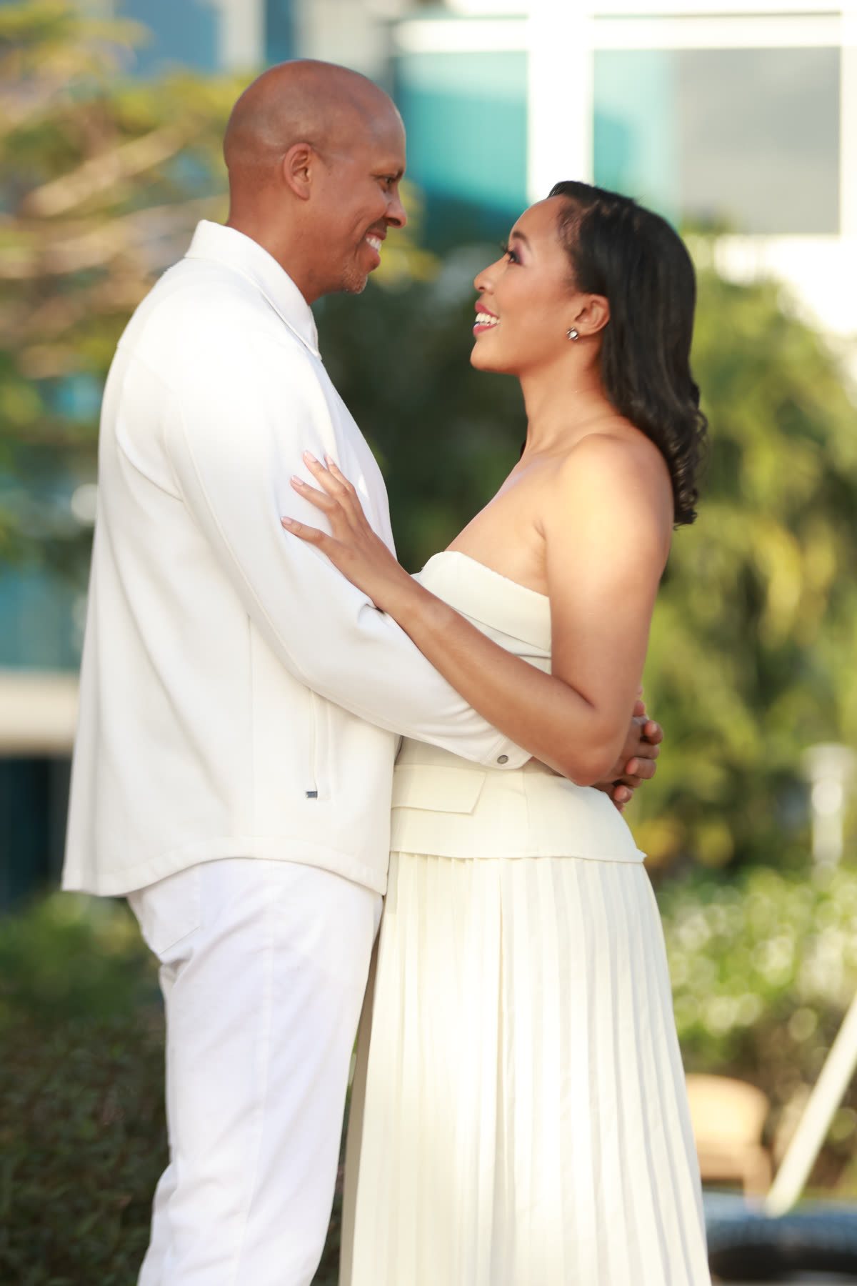 Breanna and Rob smiling at each other in a garden
